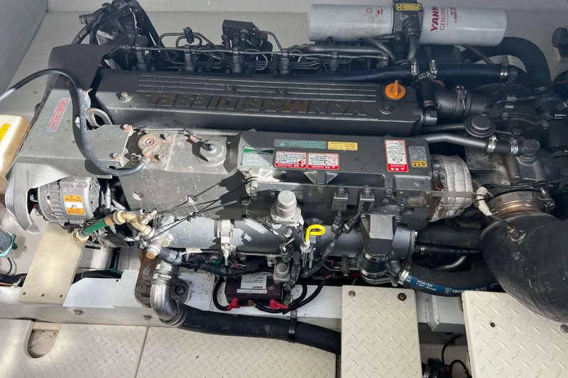 Slide: The Image of Engine of a 2004 Henriques 35 Express boat, featuring Yanmar diesel components. - 86