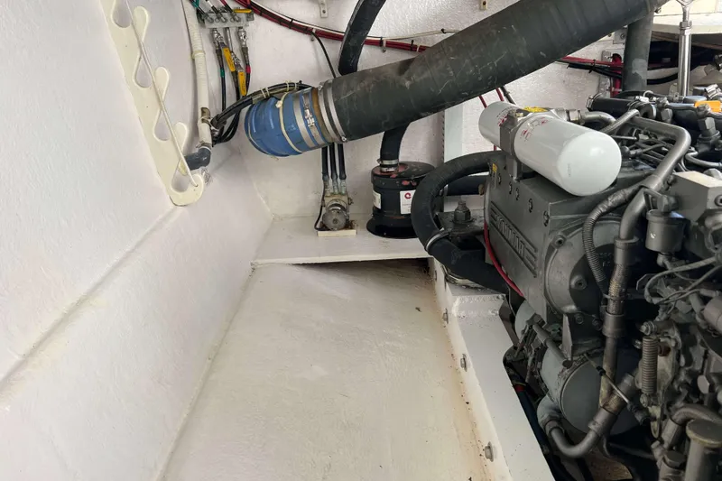 Slide: The Image of Engine compartment of a 2004 Henriques 35 Express boat, showcasing mechanical components. - 89