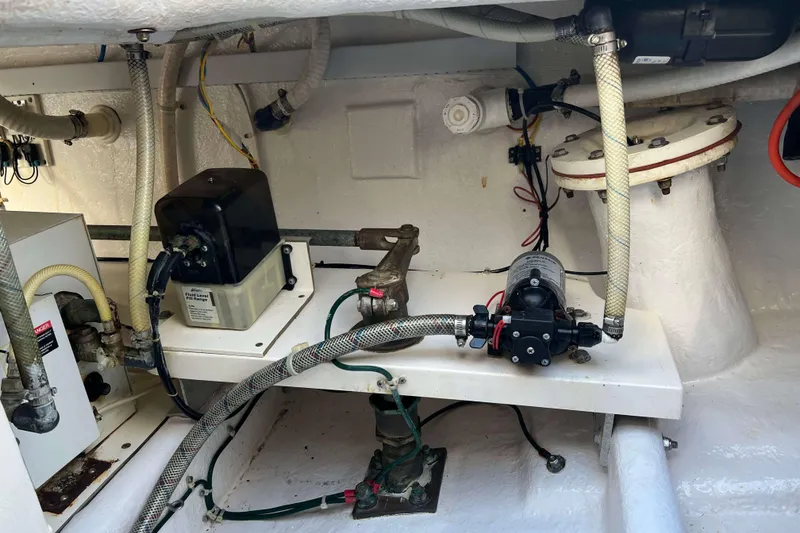 Slide: The Image of Engine room of a 2004 Henriques 35 Express boat, showcasing mechanical components and wiring. - 9