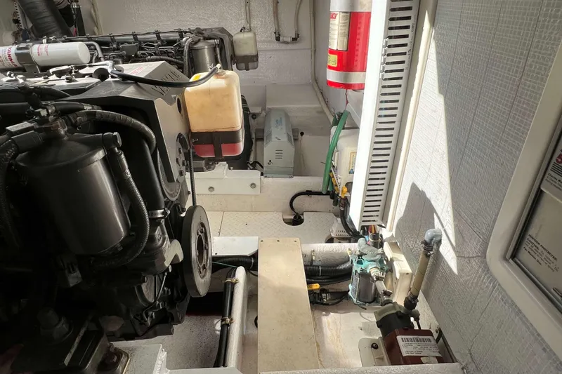 Slide: The Image of Engine room of a 2004 Henriques 35 Express boat, showcasing mechanical components. - 91