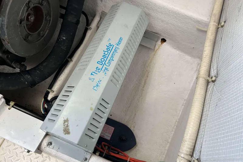 Slide: The Image of Engine compartment of 2004 Henriques 35 Express with marine heater installed. - 92