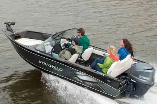 Slide: The Image of 2015 Starweld 1700 boat on trailer, parked outdoors under cloudy sky. - 0