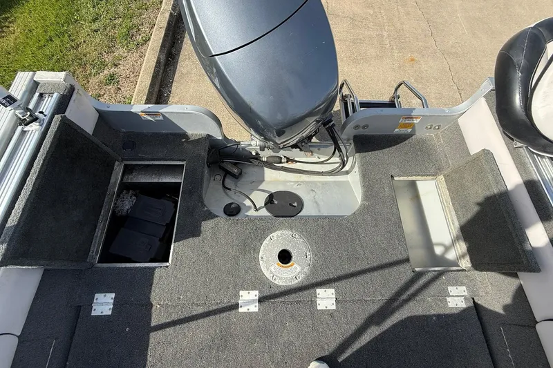 Slide: The Image of Interior of a 2015 Starweld 1700 boat, featuring carpeted flooring and storage compartments. - 15
