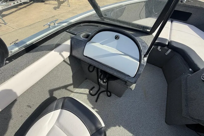 Slide: The Image of 2015 Starweld 1700 boat with dual windshields and seating, parked on concrete. - 18