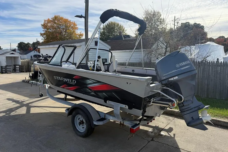 Slide: The Image of Interior of a 2015 Starweld 1700 boat with motor and seating. - 8