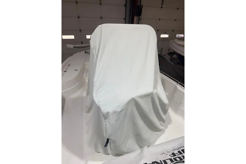 Slide: The Image of 2004 NauticStar 2200 NauticBay boat with covered console in a garage setting. - 10