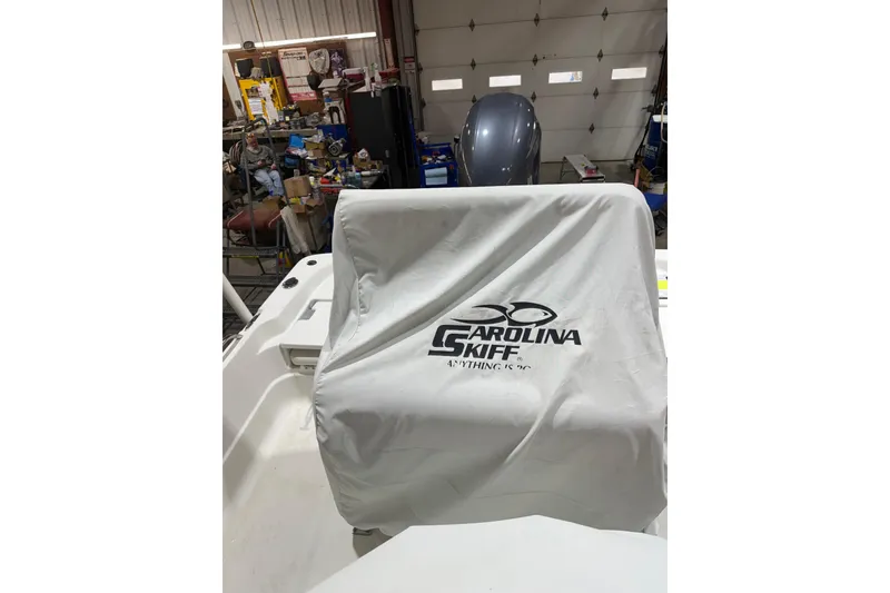 Slide: The Image of 2004 NauticStar 2200 NauticBay boat in workshop, covered with Carolina Skiff tarp. - 11