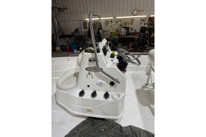 Slide: The Image of 2004 NauticStar 2200 NauticBay boat console in a workshop setting. - 4
