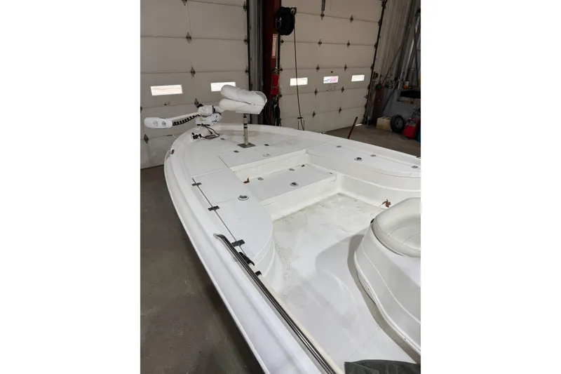 Slide: The Image of 2004 NauticStar 2200 NauticBay boat interior in a garage setting. - 6