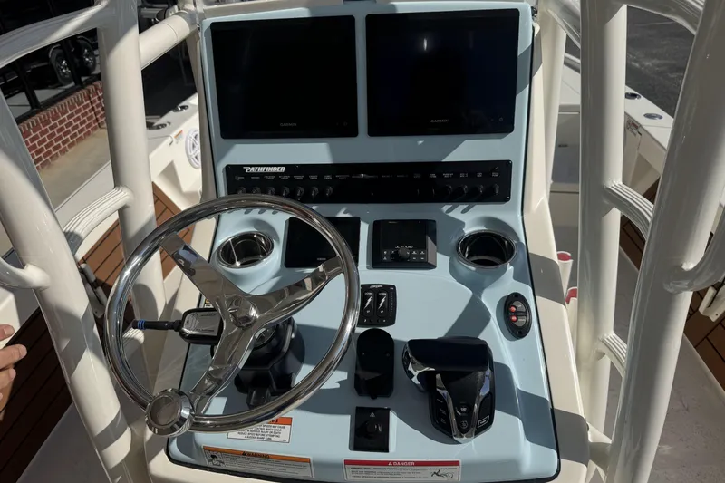 Slide: The Image of 2026 Pathfinder 2500 Hybrid boat console with steering wheel and navigation screens. - 11
