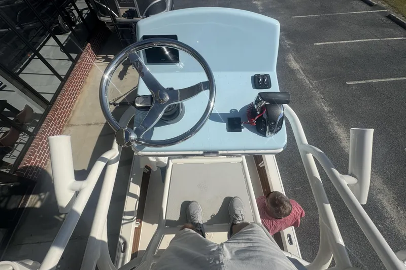 Slide: The Image of Overhead view of 2026 Pathfinder 2500 Hybrid boat helm with steering wheel and controls. - 16