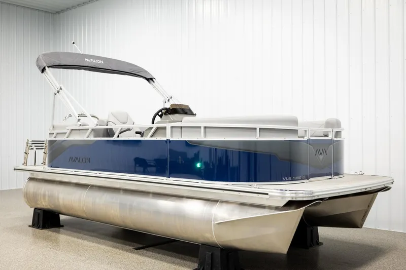 The Image of 2026 Avalon VLS QL pontoon boat with canopy, blue and gray design, side view. - 2