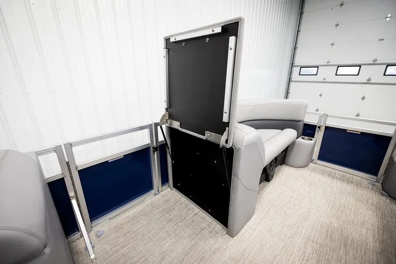 Slide: The Image of 2026 Avalon VLS QL pontoon interior with gray seating and blue accents in a showroom. - 27