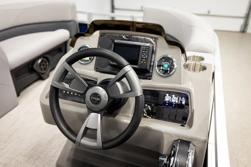 Slide: The Image of Interior of 2026 Avalon VLS QL boat with gray seating and storage compartment. - 28