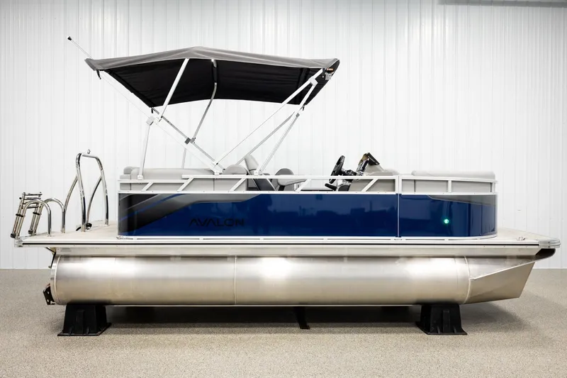 Slide: The Image of 2026 Avalon VLS QL pontoon boat with green light, showcased in a dimly lit setting. - 5