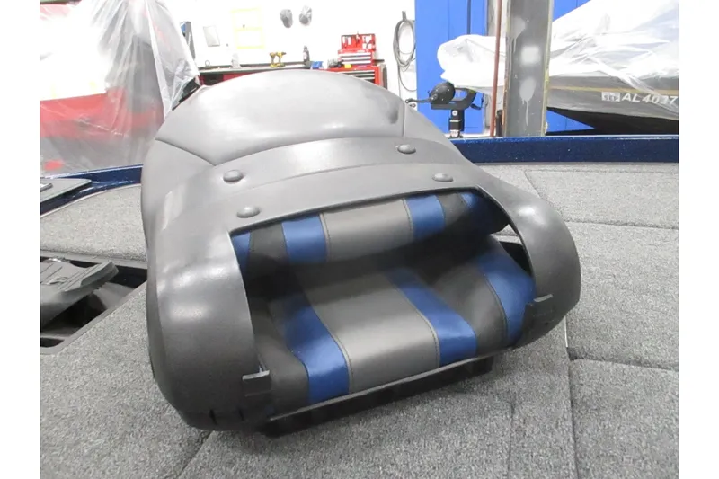 Slide: The Image of 2025 Nitro Z21 XL boat seat with blue and gray upholstery on a carpeted deck. - 13
