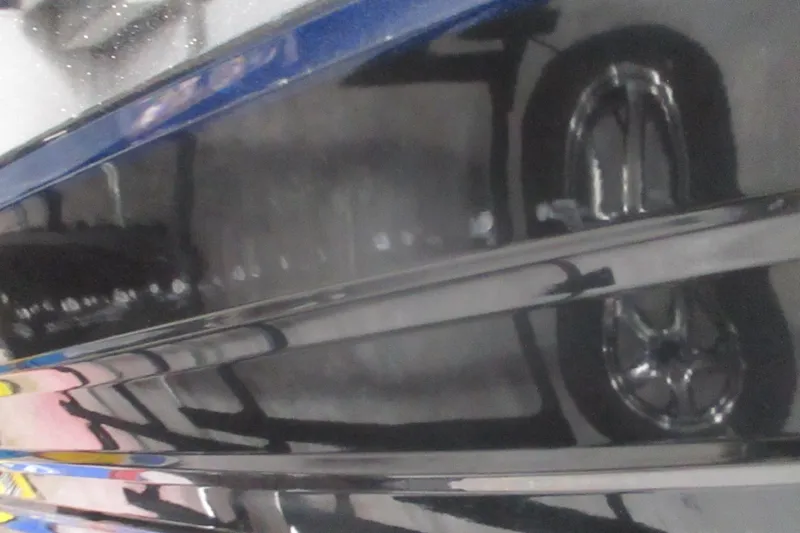 Slide: The Image of 2025 Nitro Z21 XL boat hull with sleek black finish and visible wheel reflection. - 5
