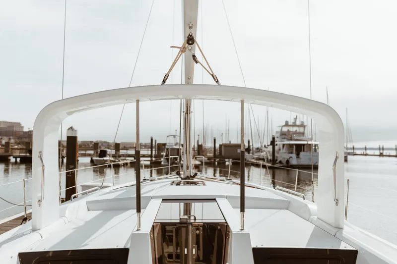 Slide: The Image of 2024 Beneteau Oceanis 51.1 yacht docked at a marina, showcasing sleek design and modern features. - 3