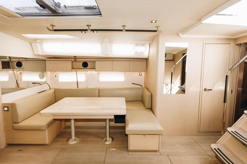 Slide: The Image of Luxurious interior of 2024 Beneteau Oceanis 51.1 yacht with modern seating and dining area. - 8