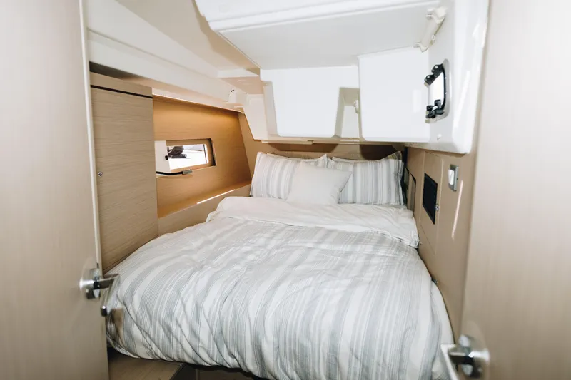 Slide: The Image of 2024 Beneteau Oceanis 46.1 cabin interior with cozy bed and modern design. - 14