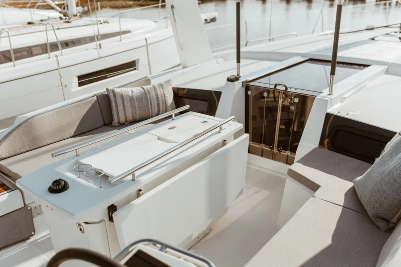 Slide: The Image of 2024 Beneteau Oceanis 46.1 yacht deck with modern seating and sleek design. - 4