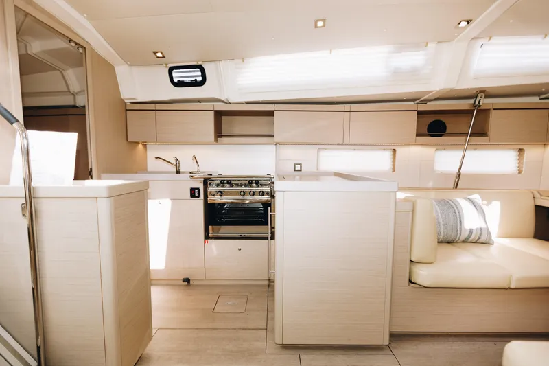 Slide: The Image of 2024 Beneteau Oceanis 46.1 yacht interior with modern kitchen and seating area. - 9