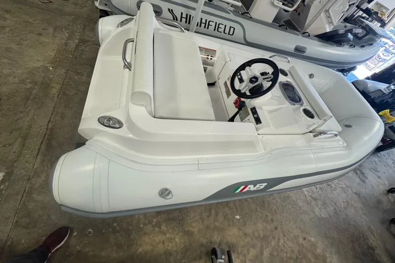 Slide: The Image of 2024 AB Inflatables ABJET 290 boat, white, in a showroom setting. - 2