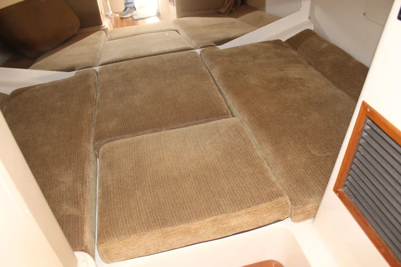 Slide: The Image of 2008 Grady-White Express 330 cabin interior with cozy seating and modern amenities. - 16