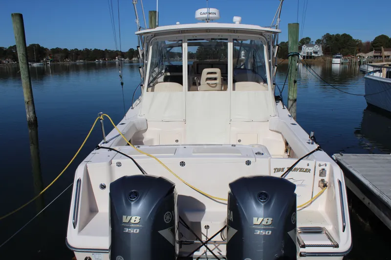 Slide: The Image of 2008 Grady-White Express 330 boat on a serene lake with Yamaha engines. - 2