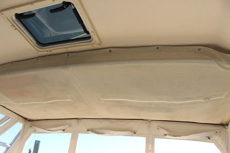 Slide: The Image of Luxurious seating on 2008 Grady-White Express 330 boat, featuring plush beige upholstery. - 30