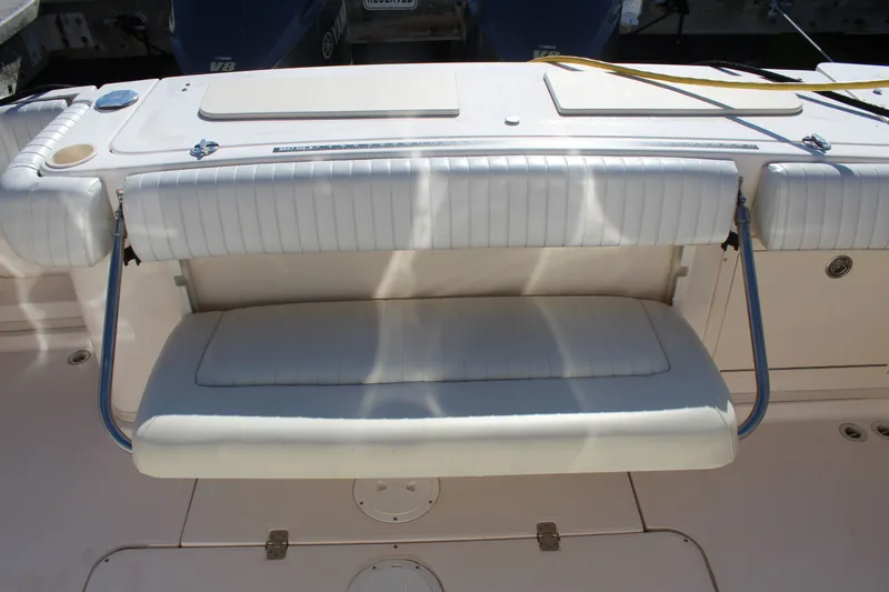 Slide: The Image of 2008 Grady-White Express 330 boat with white cushioned seating and V8 engines. - 48