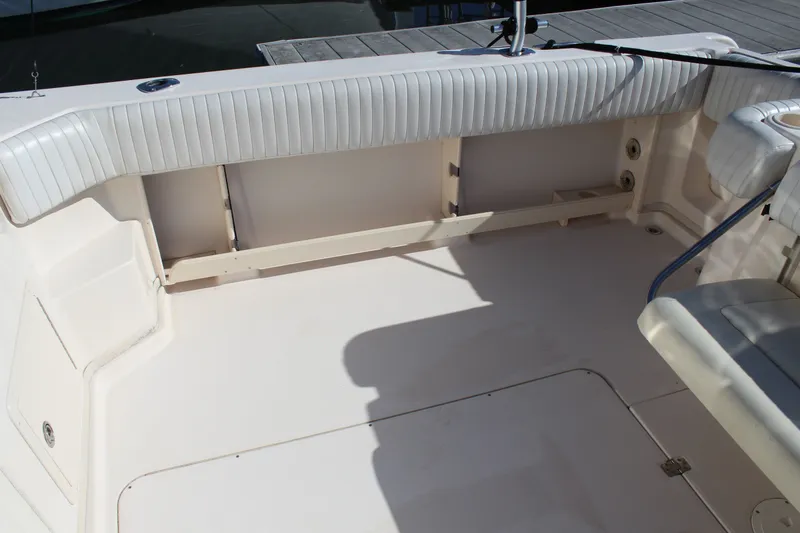 Slide: The Image of 2008 Grady-White Express 330 boat interior with cushioned seating and deck view. - 50