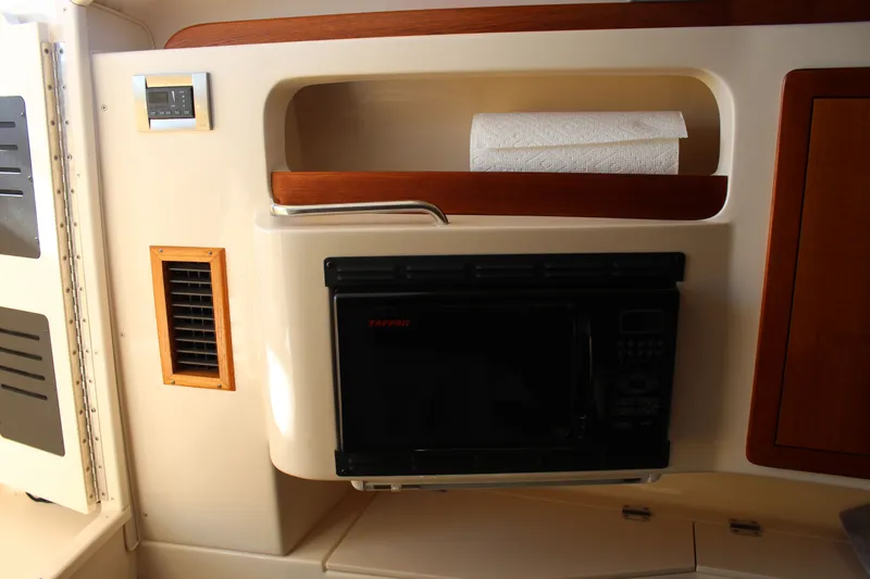 Slide: The Image of 2008 Grady-White Express 330 boat on calm water, clear sky background. - 8