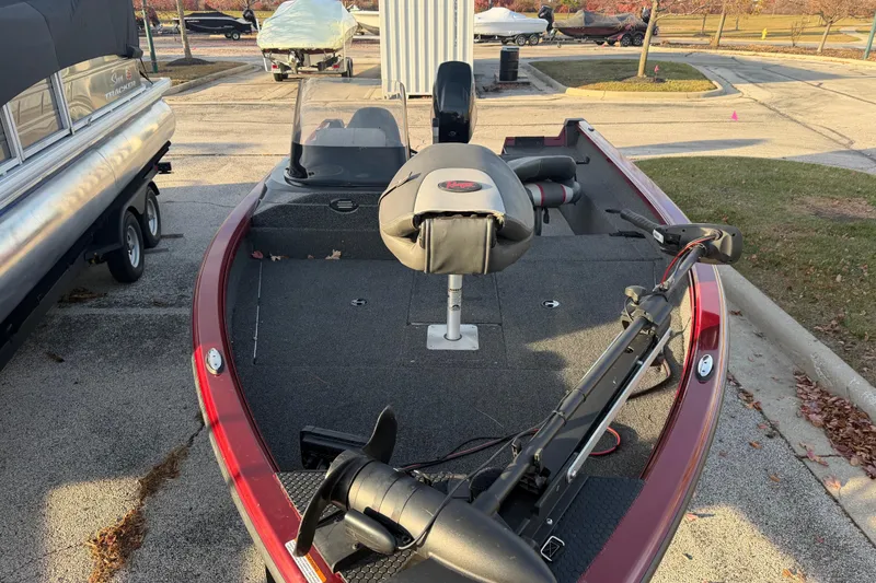 Slide: The Image of 2016 Ranger VS1680 fishing boat with trolling motor and seating, parked outdoors. - 4