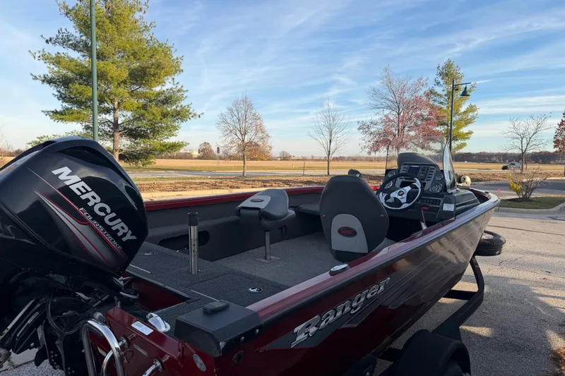 Slide: The Image of 2016 Ranger VS1680 boat with Mercury engine, parked outdoors on a sunny day. - 5