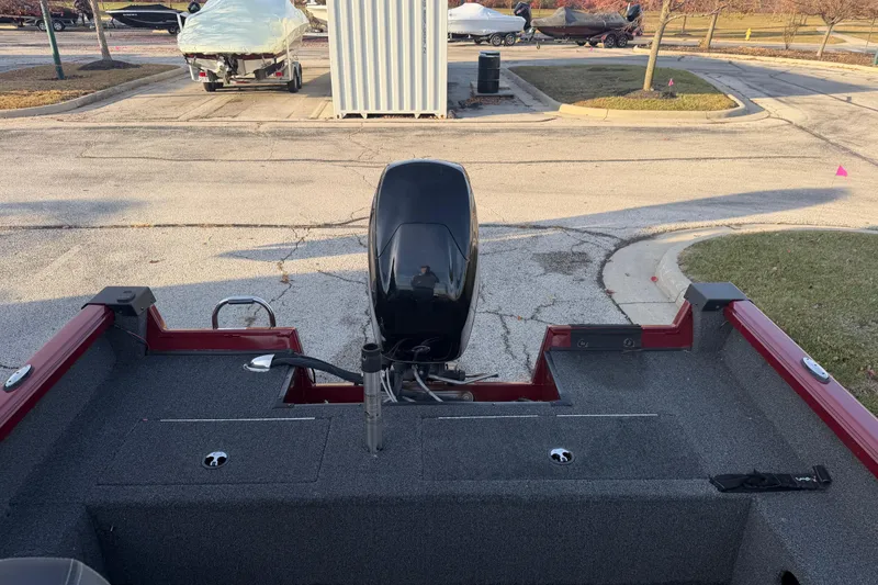 Slide: The Image of 2016 Ranger VS1680 boat with outboard motor in a parking lot. - 8