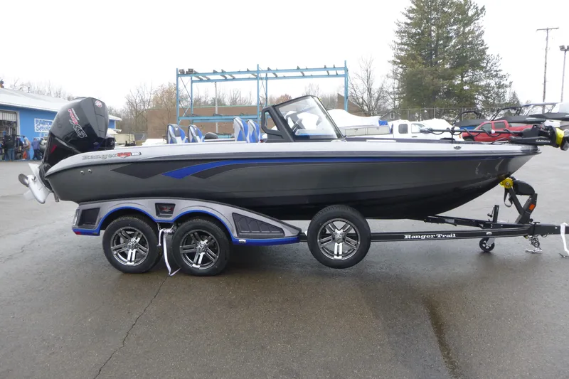 The Image of 2026 Ranger 620FS Cup Equipped boat on trailer, sleek design, parked outdoors. - 1
