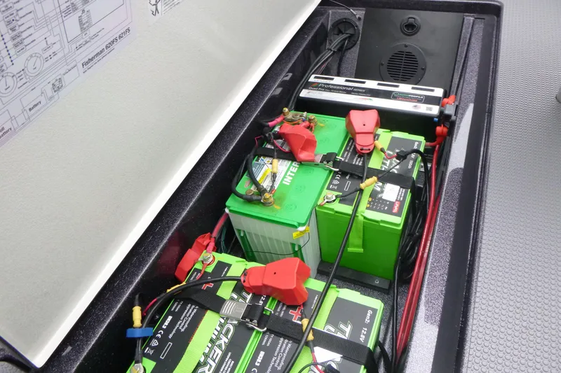 Slide: The Image of Battery compartment of 2026 Ranger 620FS Cup Equipped boat, featuring green batteries and wiring. - 21
