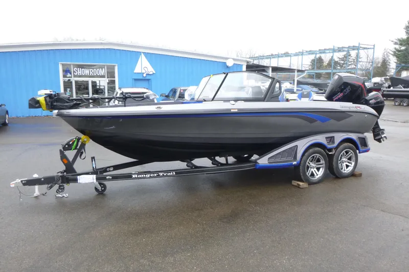 Slide: The Image of 2026 Ranger 620FS Cup Equipped boat on trailer outside showroom. - 6