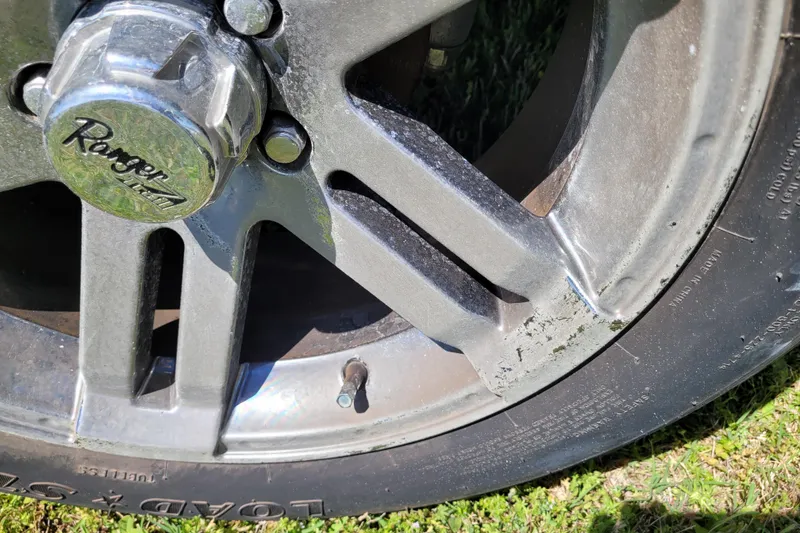 Slide: The Image of Close-up of a 2020 Ranger Z521L wheel with visible wear and tear. - 11