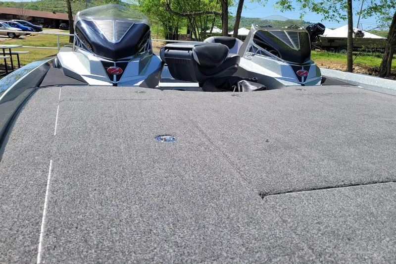 Slide: The Image of 2020 Ranger Z521L boat with spacious deck, parked outdoors on a sunny day. - 16