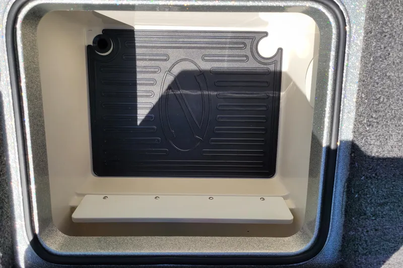 Slide: The Image of 2020 Ranger Z521L storage compartment with black mat and white shelf. - 18