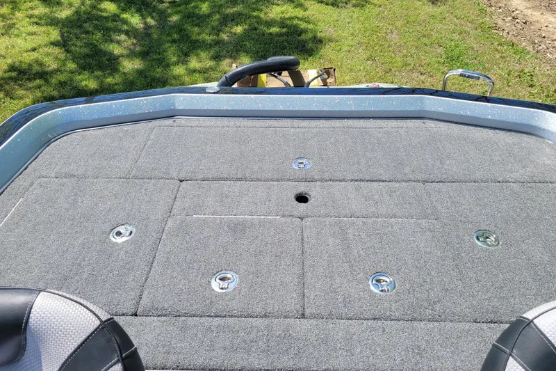 Slide: The Image of 2020 Ranger Z521L boat deck with gray carpet and storage compartments. - 22