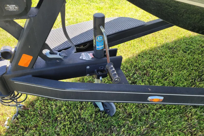 Slide: The Image of Trailer hitch of a 2020 Ranger Z521L boat on grass. - 5
