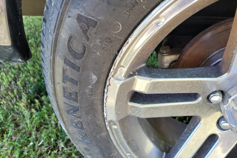 Slide: The Image of Close-up of a 2020 Ranger Z521L wheel with Kenetica tire on grass. - 7