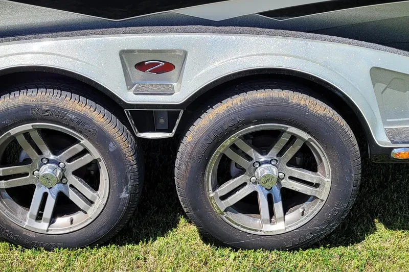Slide: The Image of 2020 Ranger Z521L trailer wheels on grass, featuring Kenetica tires and metallic rims. - 9