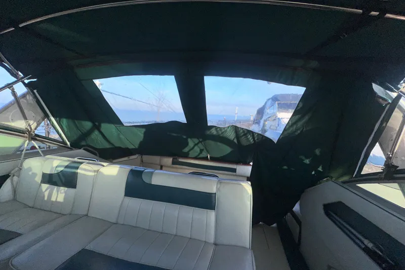 Slide: The Image of Interior view of 1987 Sea Ray 300 Sundancer boat with green canopy and seating. - 14