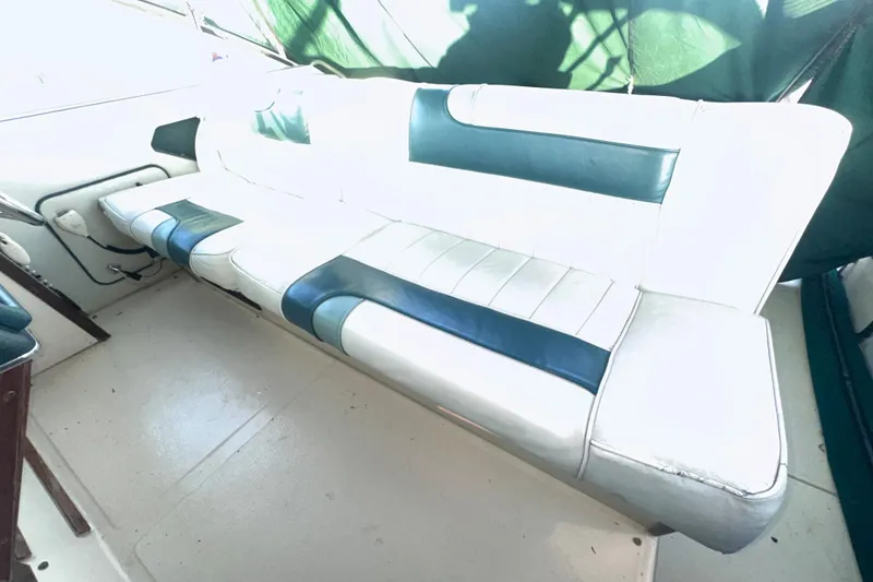 Slide: The Image of White and blue seating on 1987 Sea Ray 300 Sundancer boat interior. - 15