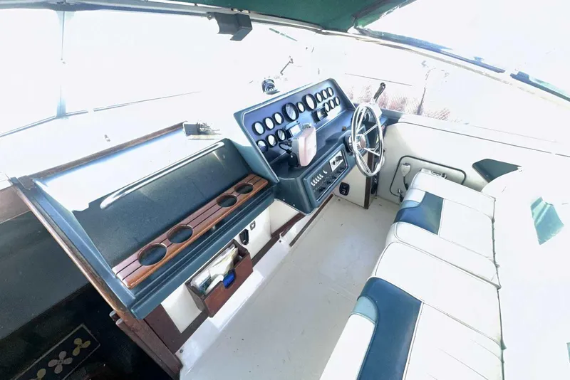 Slide: The Image of 1987 Sea Ray 300 Sundancer helm with steering wheel and instrument panel. - 16