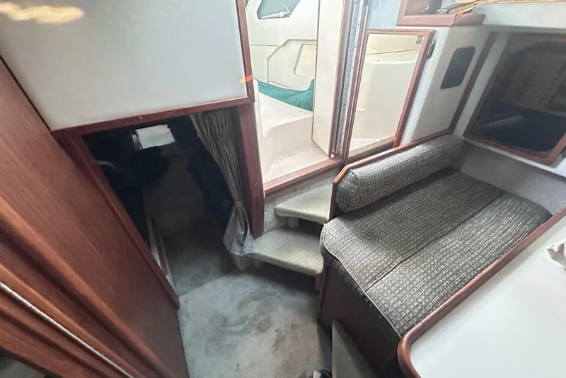 Slide: The Image of Interior of 1987 Sea Ray 300 Sundancer boat with seating and stairs. - 20